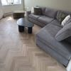 beige herringbone dryback luxury vinyl flooring in modern living room